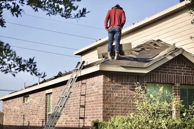 Professional roofer working on a residential roof in Dardenne Prairie